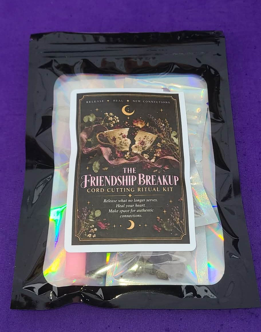 The Friendship Breakup Card Cutting Ritual Kit by Release & Heal, packaged in a black resealable pouch with an iridescent white insert, set against a solid purple background.